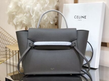 CELINE BELT MINI mini grained calf leather handbag with 1 leather handle, 1 detachable shoulder strap and 1 zipped pocket on the outside back. This handbag features two closure options: top flap and zipper. nSize 11 X 9 X 7 inches (28 X 23 X 17 cm)n100% Calfskin leathern100% Calfskin leather liningnGolden metal hardwarenShoulder or handheldnMagnetic snap top flap closure and top flap lower zipper closurenInterior double flat pocketsnBack exterior flat pocketnDetachable leather shoulder strap 14 inches (36 cm)nTote handle 4 inches (9 cm)n Protective foot studsn No. 175523 p1050