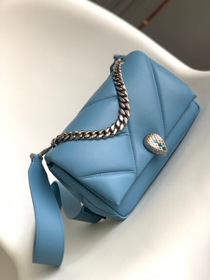 ❣️ Chip Edition❣️n✨BVLGA**💫"SERPENTI CABOCHON" Collectionn🔹With charming large graphic patternsn bold metallic details⚜️n The world of Serpenti shines through with a unique designn and contemporary style that is refined and functional🌟n🔹The geometric motif of the large Matelassé cabochon patternn draws its inspiration from the mesmerizing surfaces of the cabochon oval-cut gemstones that make up this bag. The Niagara sapphire blue calfskin body is soft and smoothn🔸The gold-plated brass serpent head clasp draws inspiration from vintage Bulgari watchesn🔹The center is decorated with subtle blue onyx serpent scalesn🔹and red enameled eyes for an innovative touchn The classic BVLGARI chain adorns the flap like a necklace and can also be used as a delicate handle, reflecting the essence of the jewelry brandn🔹The bag is equipped with an adjustable and detachable leather shoulder strapn🔹which can be used as a handbag or clutch for Versatile and versatile, it can be used day or night. It has one organizer compartment, one internal zipper pocket and one internal open pocket.