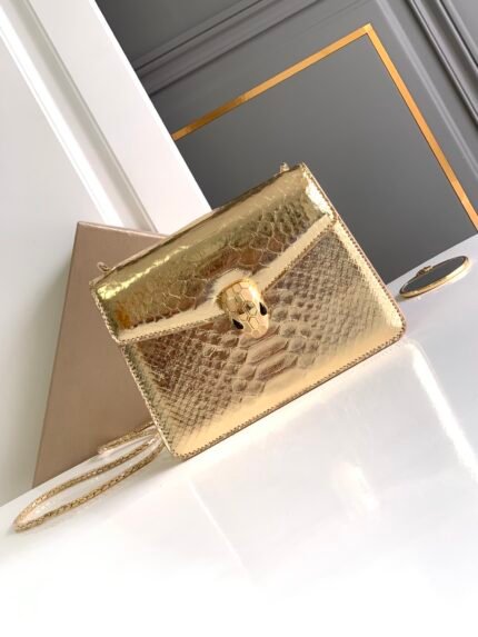 ✨BVLGA**✨VIP CUSTOMIZEDn🔹SERPENTI FOREVER Collection Small Crossbody Bagn🔸Handcrafted in golden MOLTEN python skin, it is a subtle blend of a glittering, glossy effect and a delicate, soft touchn 🔸Reinterpreting its timeless charm with precious materials and exquisite craftsmanshipn🔹The piece is accompanied by a serpentine chain shoulder strap with an iconic snake head magnetic claspn🔸The scales and design of its seductive allure are inspired by the SERPENTI jewelry collection of the 1960sn 🔸Featuring a single compartment, a back patch pocket, a mirror pocket with personalized vanity mirror, an inside metal plaque engraved with the BULGARI brand logo and a back decorated with the BULGARI metal logonSize: 20 X 15 X 5 Cm618790081