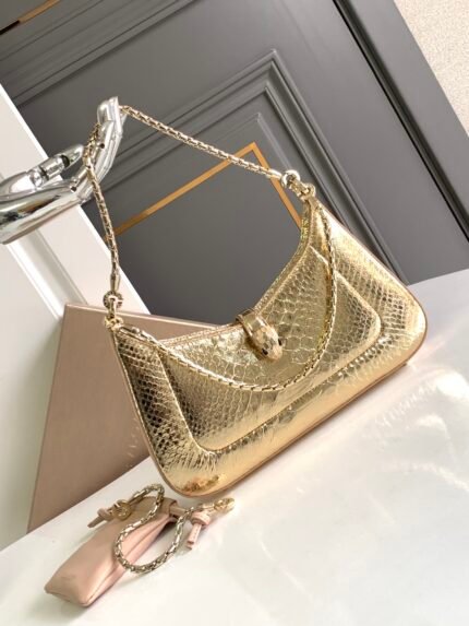 ✨BVLGA**✨VIP CUSTOMIZEDn🔸SERPENTI BAIA Shoulder Bagn🔹Handcrafted from golden MOLTEN python skin n🔸A subtle blend of shimmering effect, delicate softness and innate charmn A modern, minimalist interpretation of a timeless masterpiece n🔸The bag is versatile, adding style and charm to daytime looks n🔹With three detachable snake chains and an extra chain mechanism, the shoulder strap can be extended as needed for a variety of wearing styles. n🔸 The piece is adorned with the iconic snake head magnetic clasp, with its seductive scales and design inspired by the SERPENTI jewelry collection of the 1960s. The n🔹 features one compartment with top zipper closure, one interior open flat pocket and BULGA** Bulgari metal logo on the back nSize; 27.5 X 18 X 4.5Cm2932080581